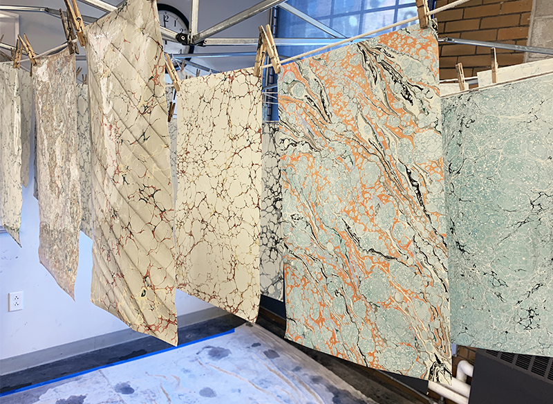 Hand-marbled paper made by bookbinding students