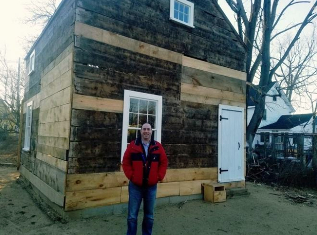 Eric Menzer stands in front of the newly-renovated structure. Photo courtesy Wicked Local / Alex Cook.