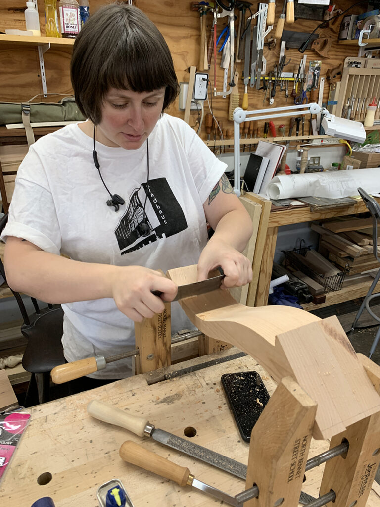Eve Radovsky working on a chair leg