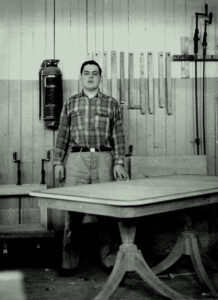 Historic photo of a furniture making student