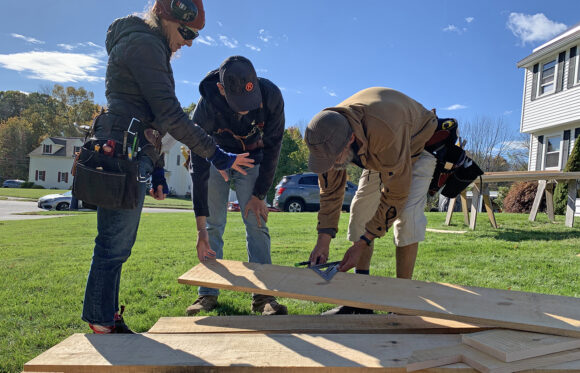 Carpentry students measuring wood