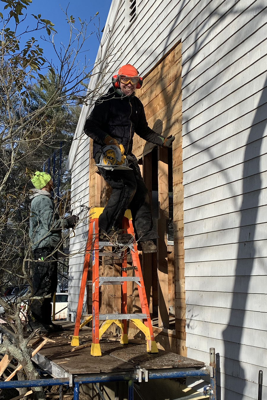Jason McKenzie working on the side of a house