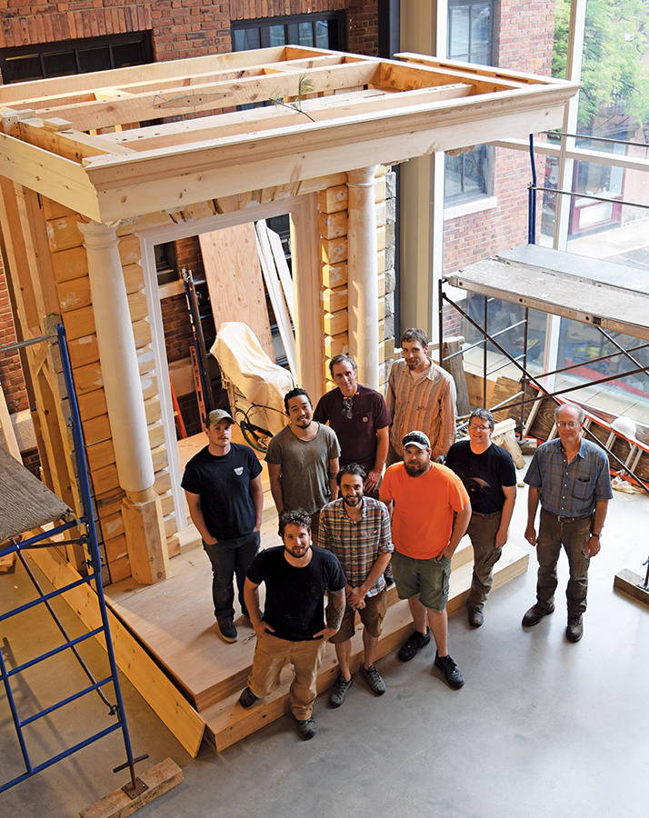 The PC students standing in front of the constructed entryway replica.