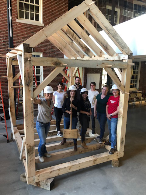 Students posing with constructed timber frame