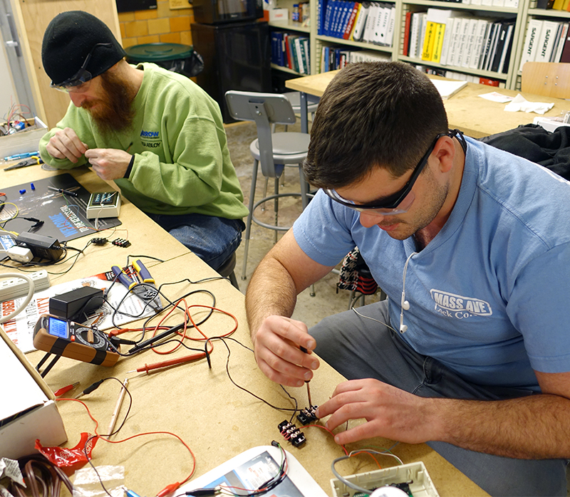 Locksmithing students wiring electronic systems