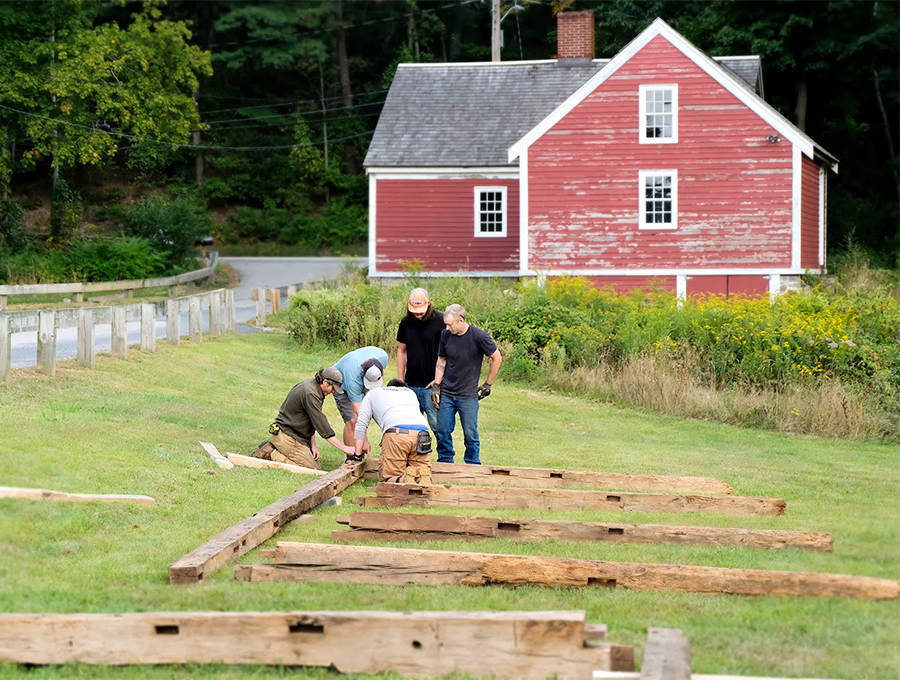 Students working on timber frame beams