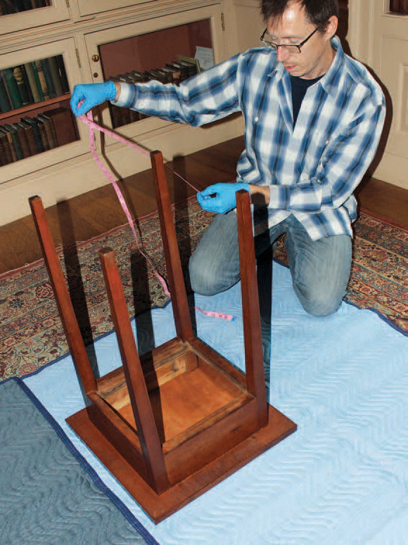 Boyd Allen measuring the Dickinson desk.