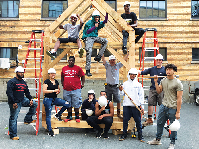 Group shot of students on a timber frame