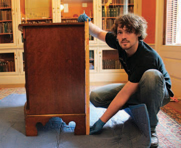 Caleb Schultz measuring Dickinson's chest of drawers