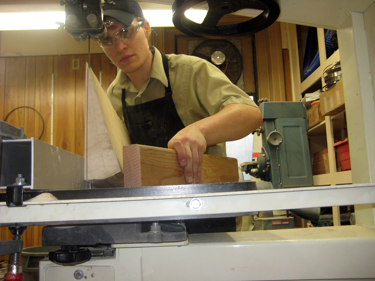 Corey makes the first cuts in the aspen wood used to make the back and sides.
