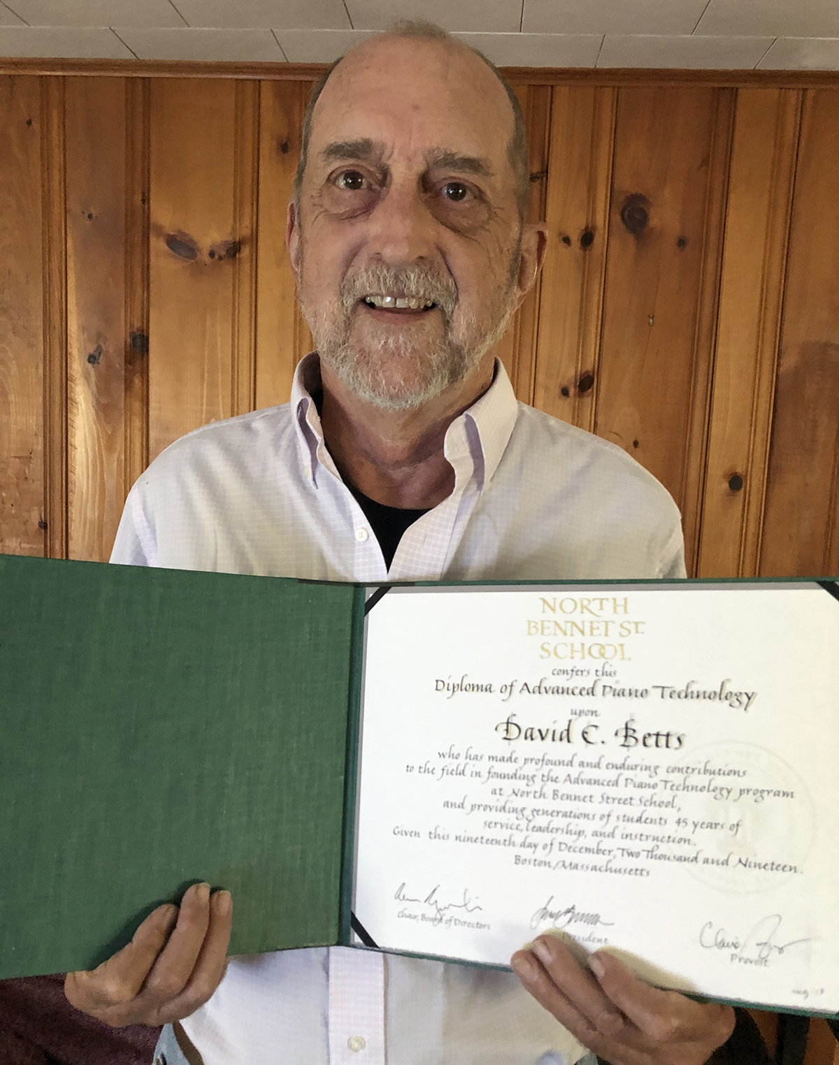 David holding his honorary diploma