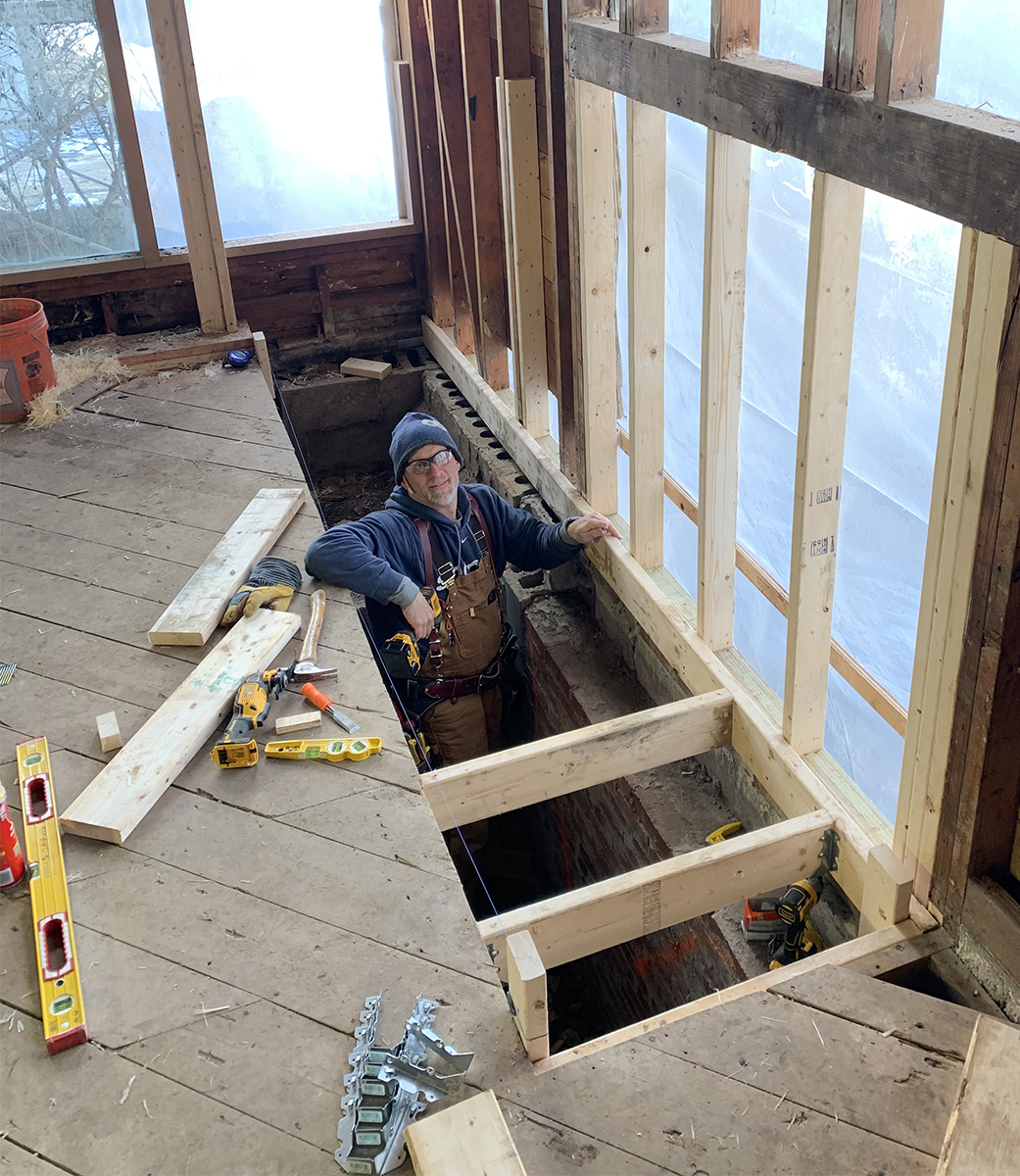 Carpenter framing a window and floor