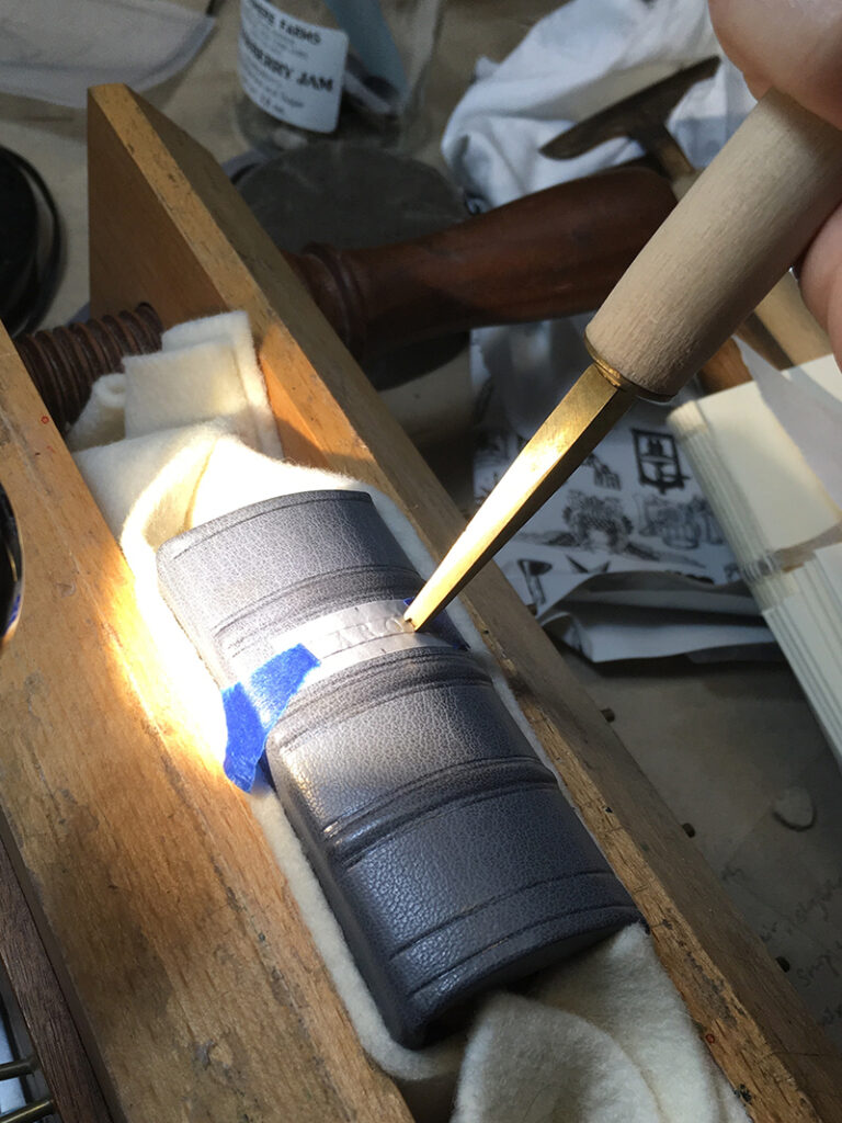 Yi Bin tooling on a leather book spine