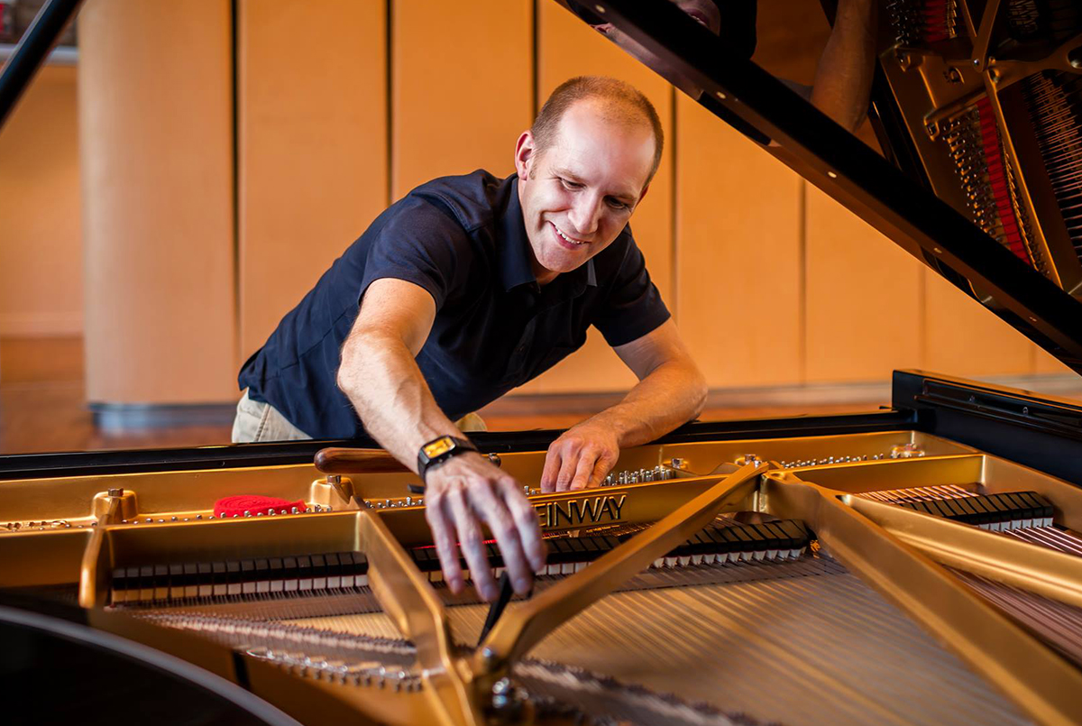 Joel tuning a piano at Carnegie Hall. Photo by Chris Lee.