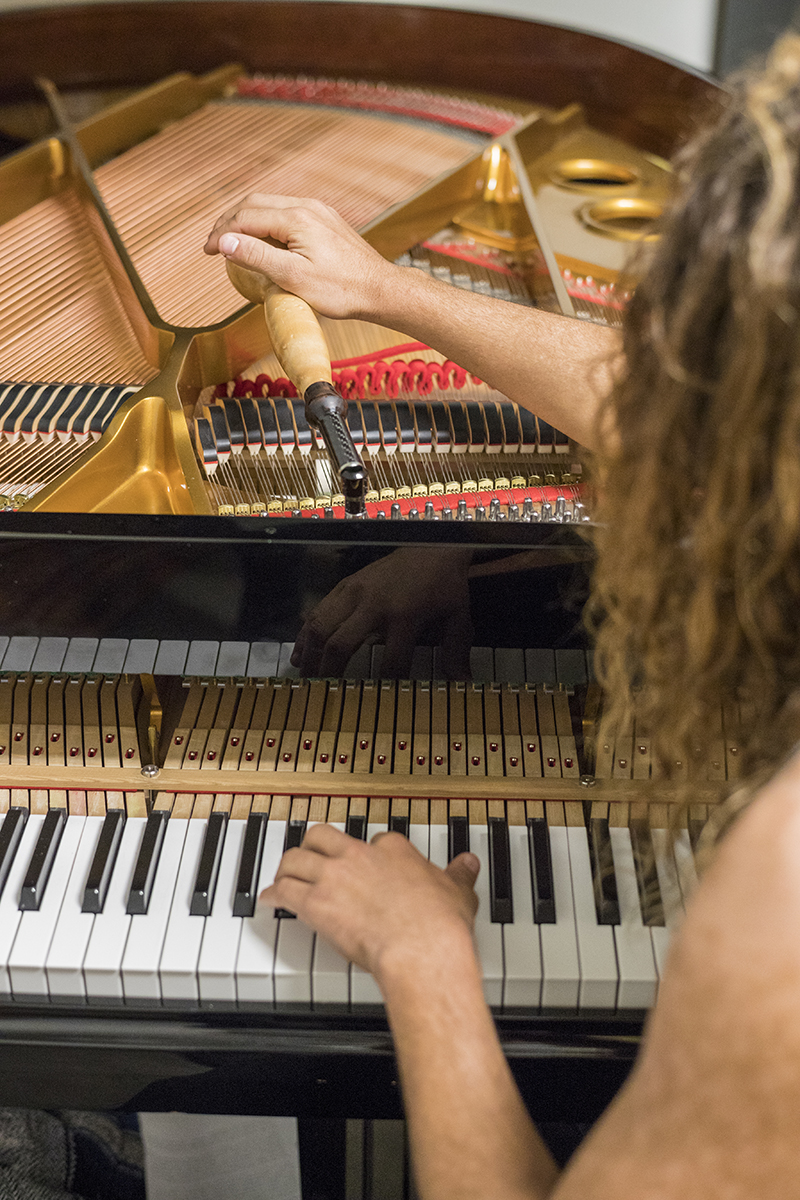 Student tuning a piano