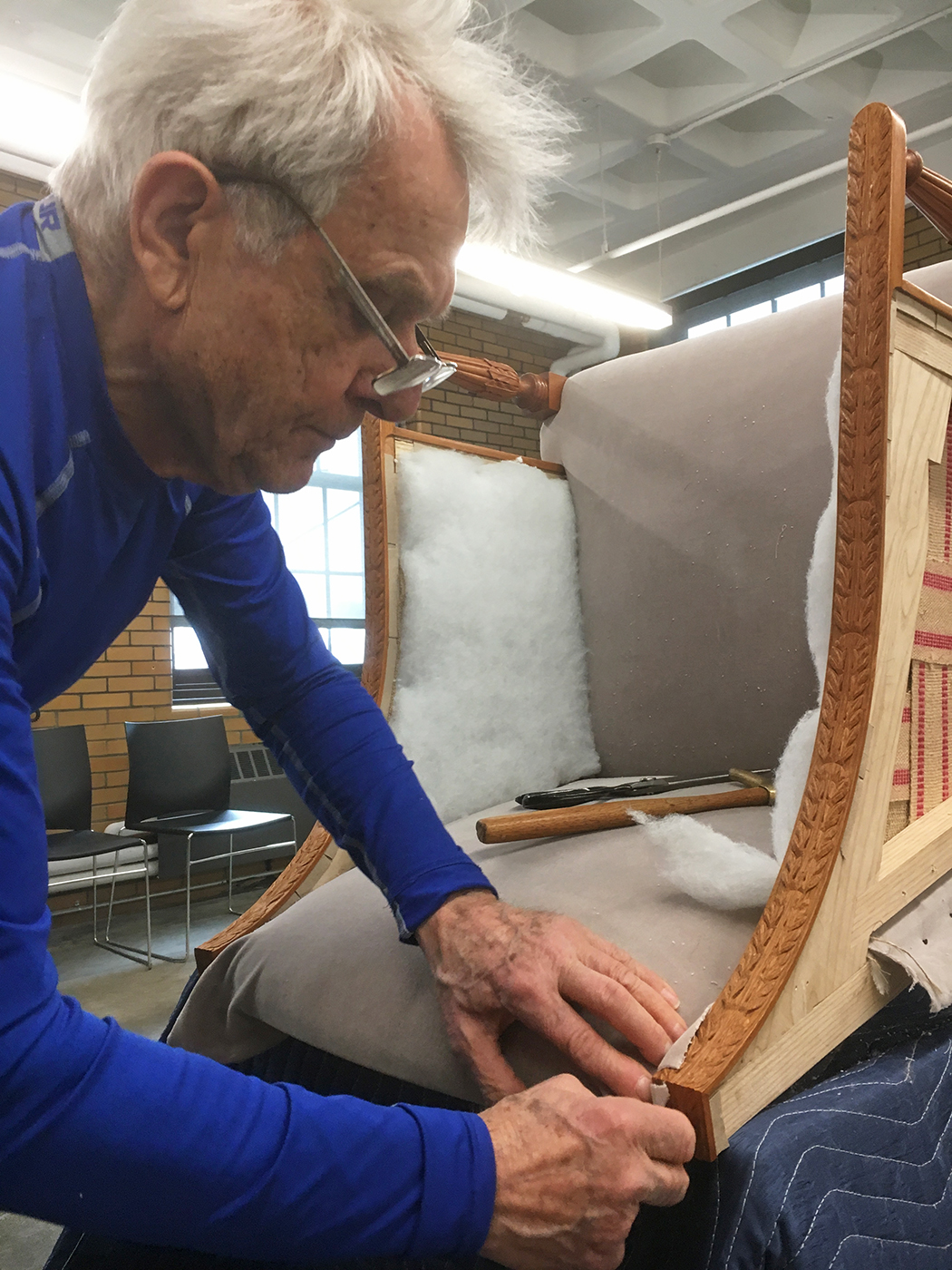 Joseph upholstering Aspen Golann's chair