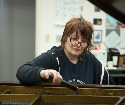 Michelle Stranges at work tuning a piano