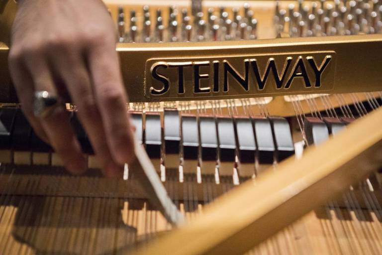 Nowell Gatica, chief technician at Steinway Hall in Dallas, demonstrates the tools and techniques he uses to tune a piano at the Van Cliburn Recital Hall in Fort Worth.