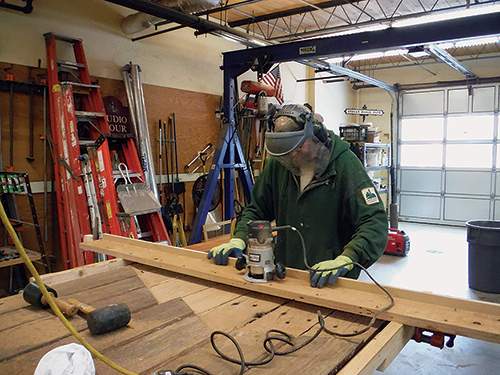 Greg Ghazil (shown above) and Steve Brown of Mount Auburn's preservation department routed supports and patches for the door.