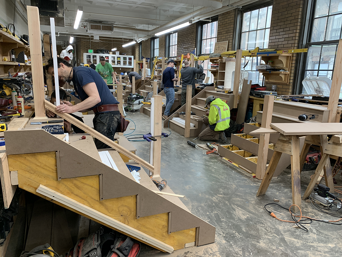 Carpentry students constructing small flights of stairs in groups