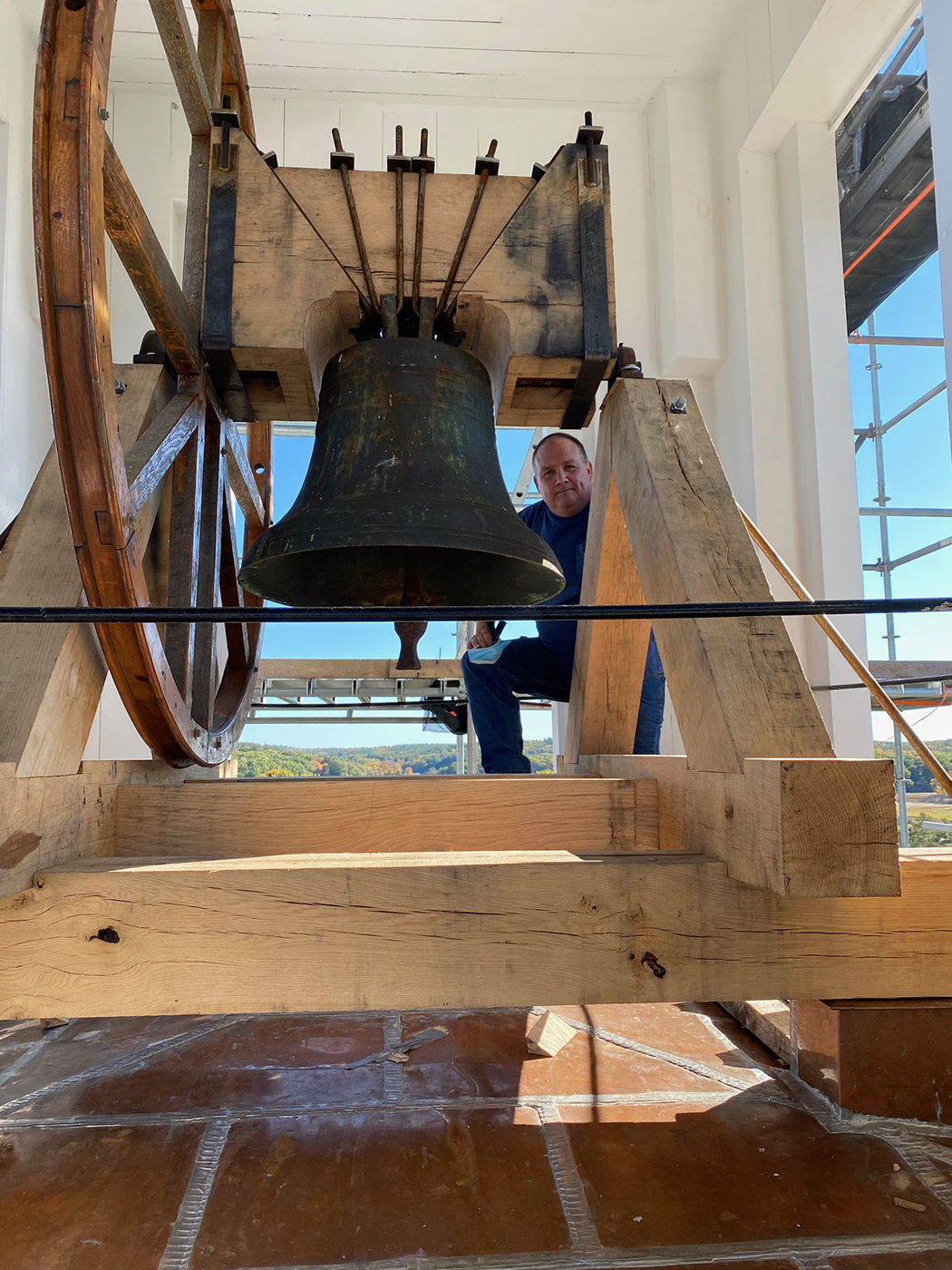 Steve in the steeple with the finished cradle and bell