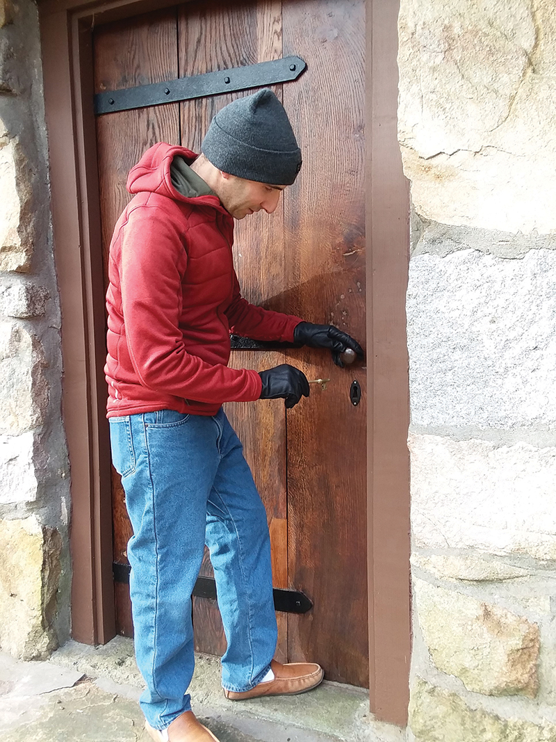 Yanni Tsipis trying his new custom key into the restored door
