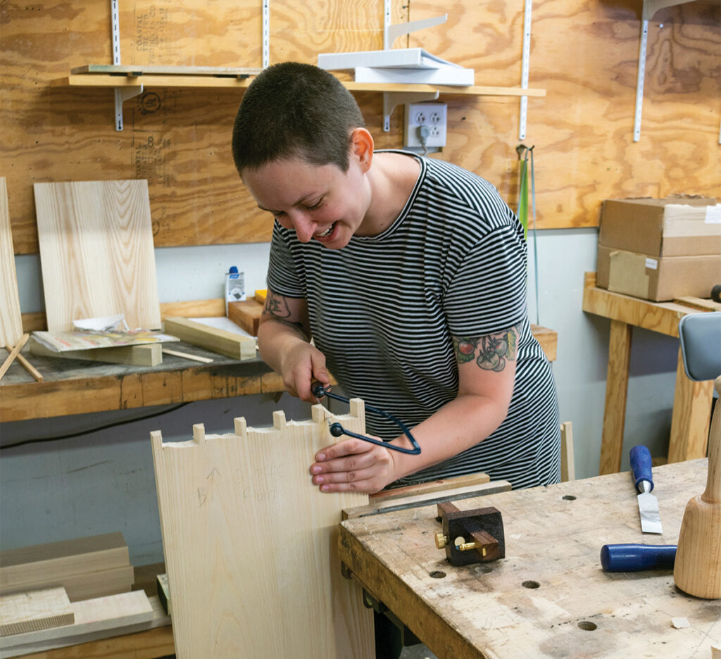 Student cutting dovetails