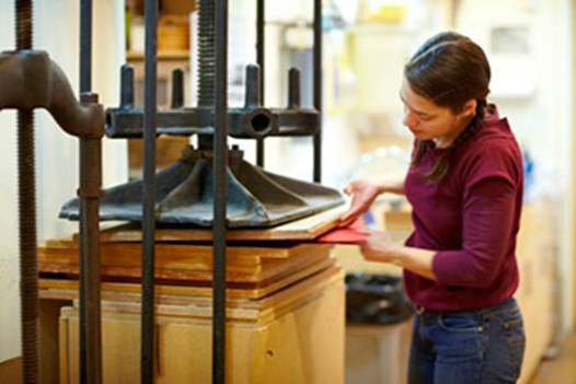 Bookbinder working for library