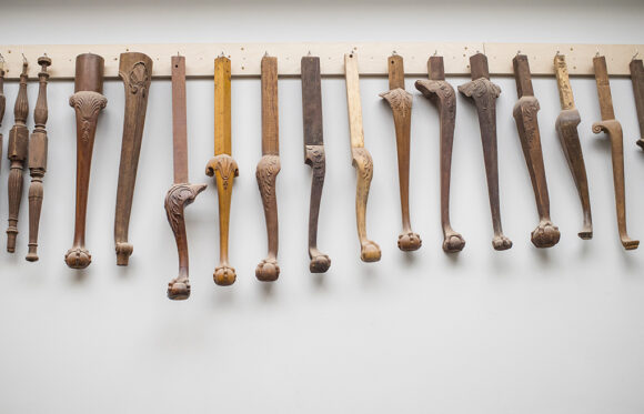 Furniture leg samples hanging on a wall