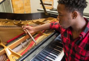 Student tuning a piano