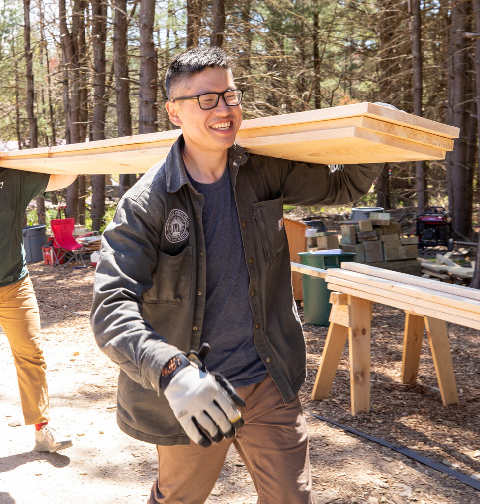 Viet carrying lumber