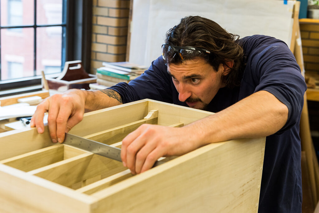 Student measuring cabinet drawers