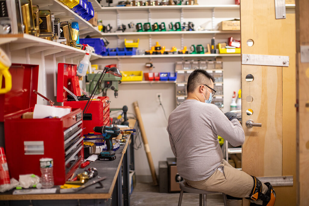 Student installing door hardware