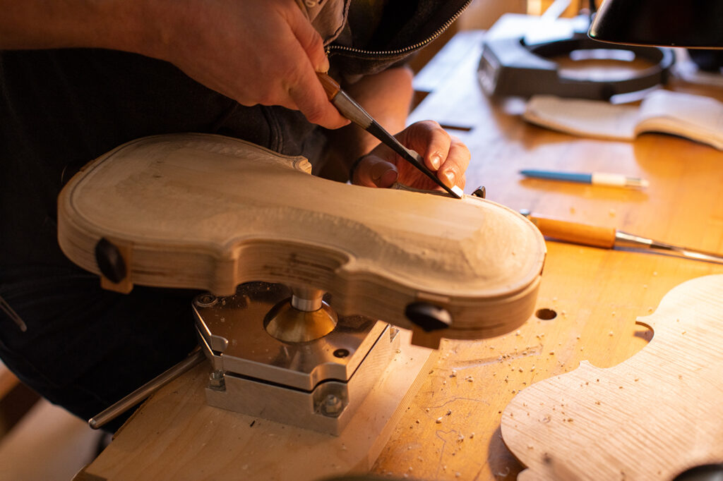 Violin Making student shaping a plate