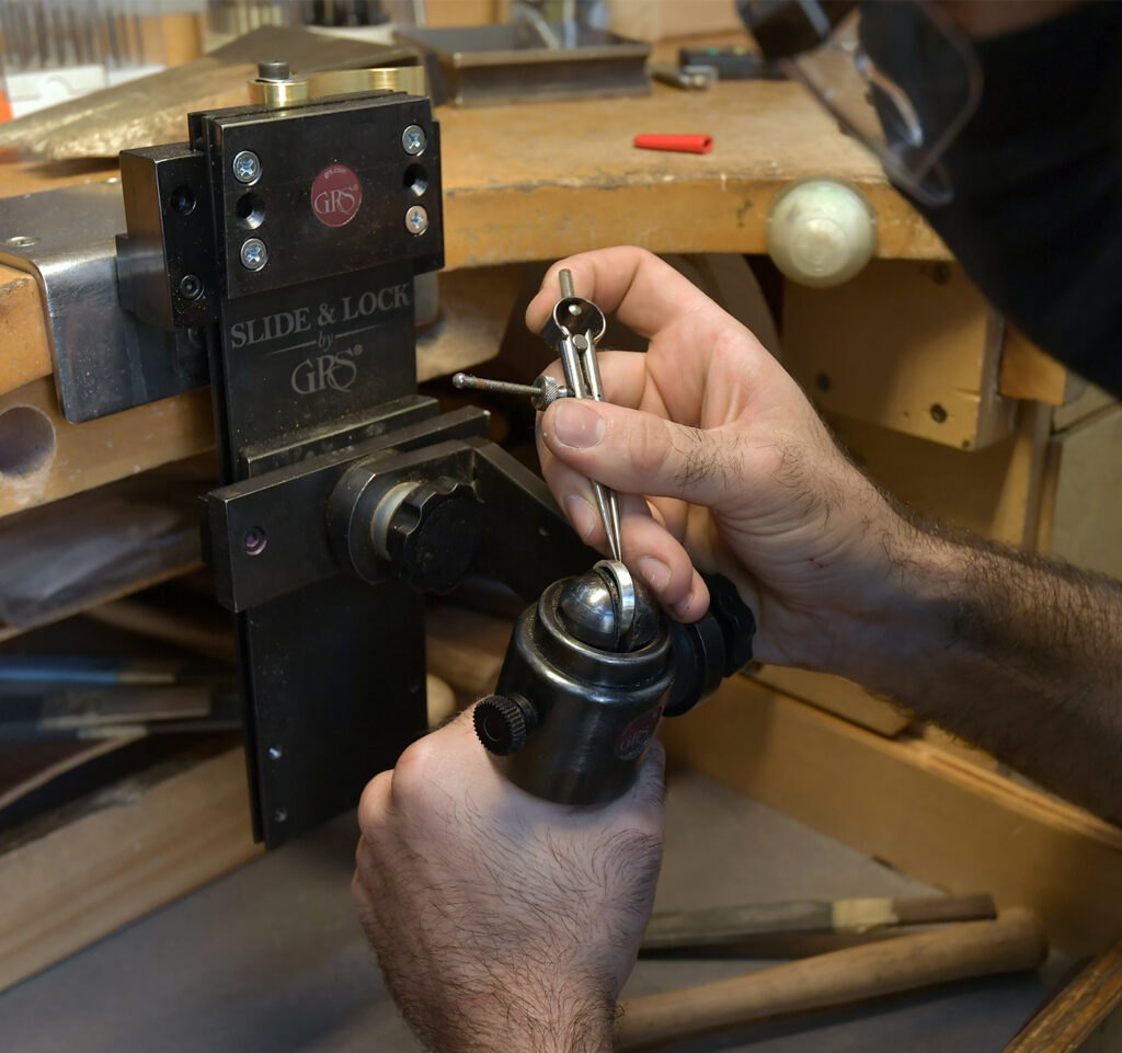 Student measuring a ring they're working on