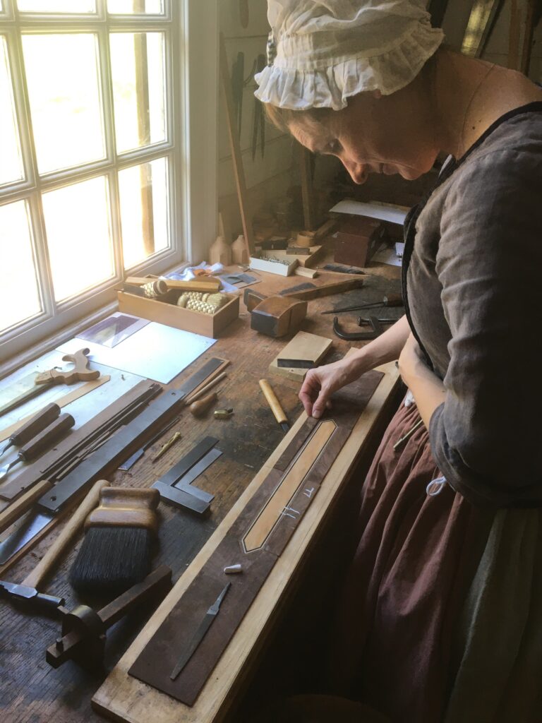 Melanie Belongia building the nameboard veneer for a recently finished Spinet