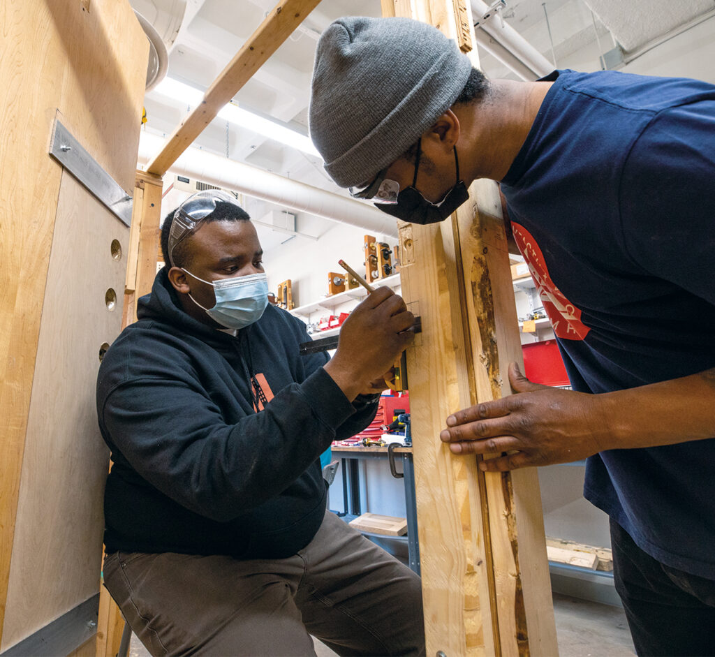 Eddy working with a student installing hardware