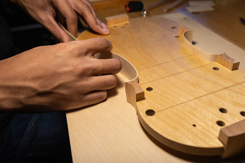 Student working on violin ribs