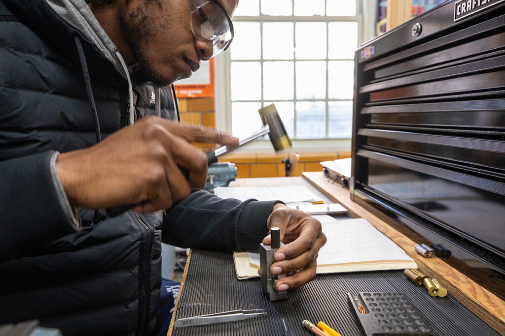 Locksmithing student working on lock hardware