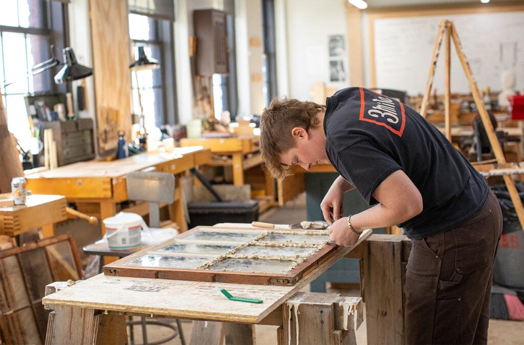 Preservation Carpentry student restoring an old window