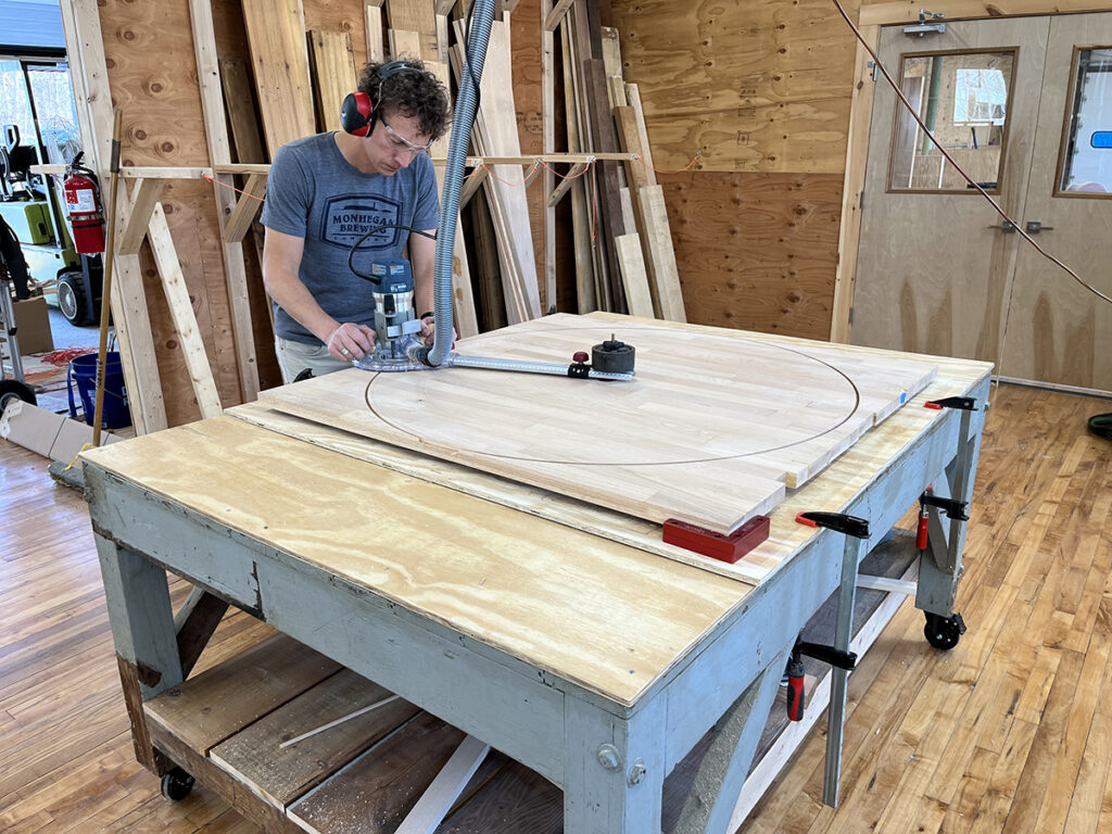 Sandy cutting the table top in his workshop