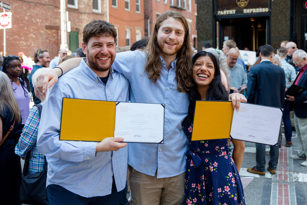 Students holding their diplomas