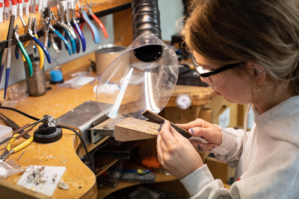 Jewelry Making student filing at her bench