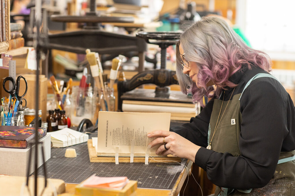 Abra restoring a book at her NBSS bench