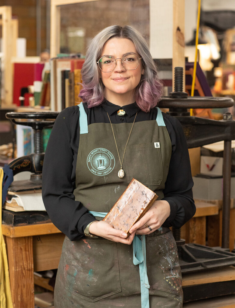 Abra holding one of her bound books