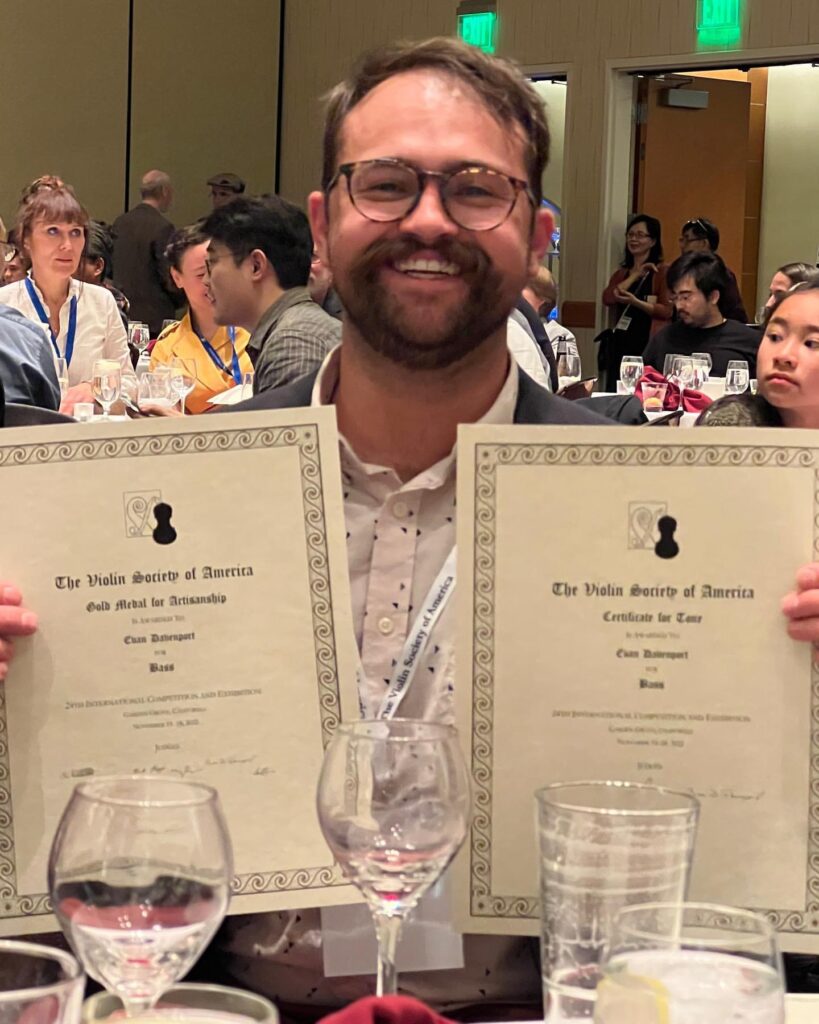 Evan holding his two certificates at the VSA Competition