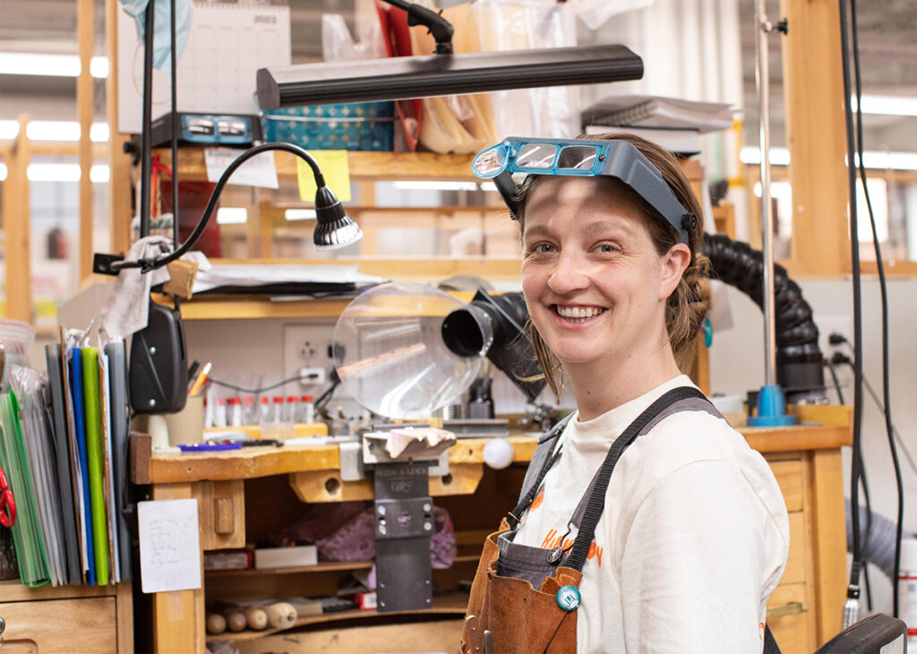 Jewelry Making student sitting at their bench and smiling