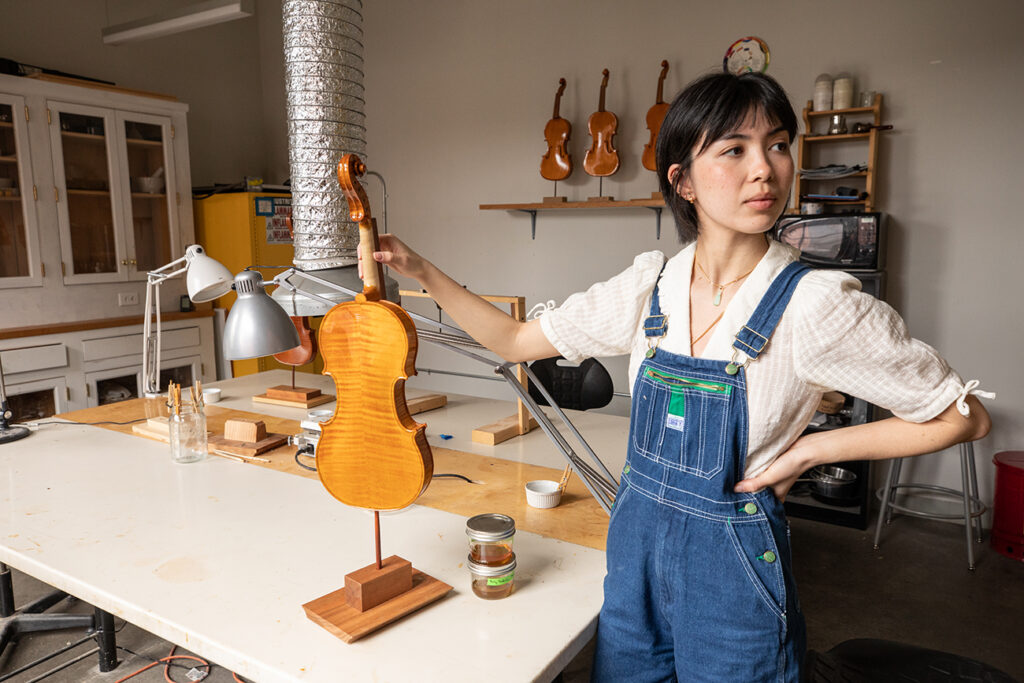 Emmeline Nguyen in the varnish room with her first violin
