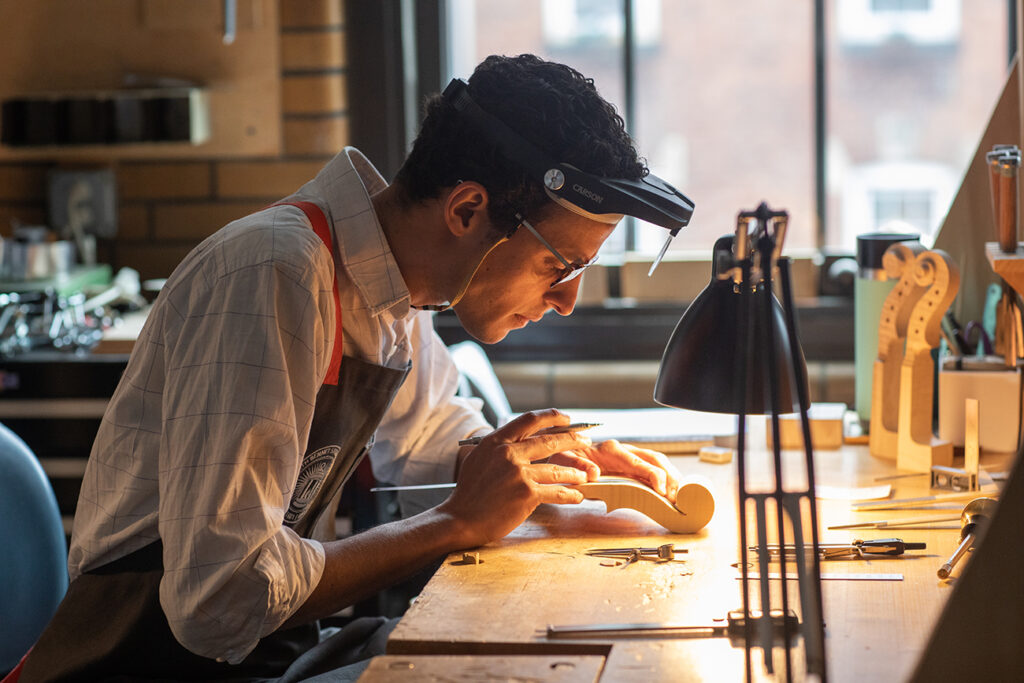 Eric Rodriguez working on a scroll