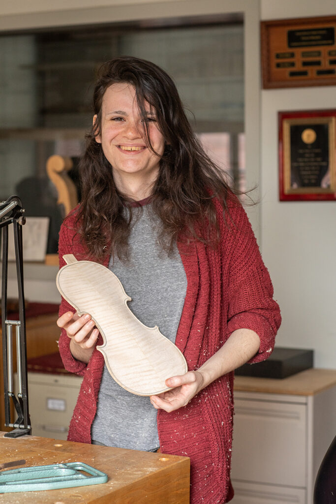 Rhea Burdick holding a violin back plate